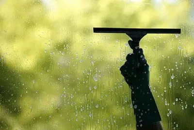 Squeegee cleaning window at Welcome bay & Hairini 